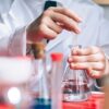 Serious kid playing with chemical liquids