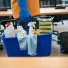 Cleaning service employee uses a special set of gadgets for cleaning and disinfection - a bucket, sponges, spray, napkins, detergents,gloves