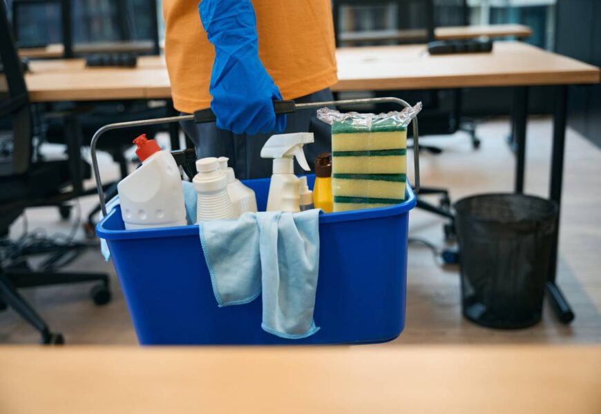 Cleaning service employee uses a special set of gadgets for cleaning and disinfection - a bucket, sponges, spray, napkins, detergents,gloves